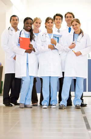 This is a picture of seven doctors. They all have white doctors coats on three are males and four are women.