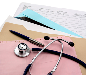 This is a picture of papers and files laid out on a desk with a stethoscope and a pen