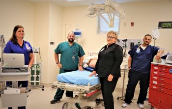 This is a picture of a hospital bed with the nurses in a Trauma room.