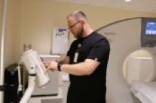 This is a picture of a nurse playing with the MRI machine