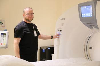 This is a picture with a female doctor holding a xray and a male doctor looking at the xray with her